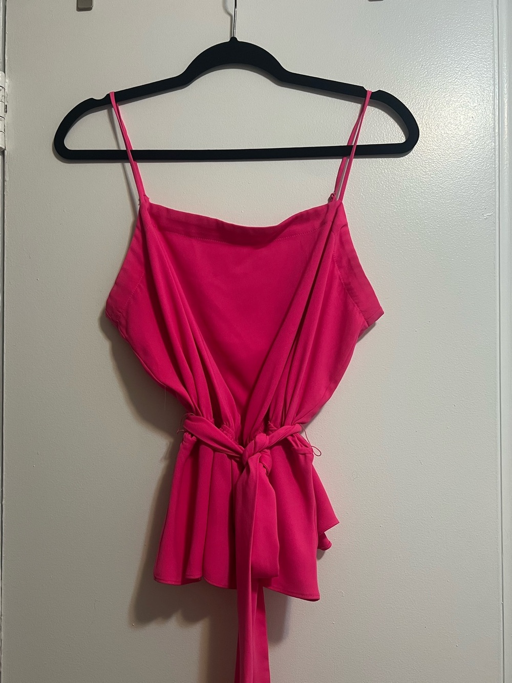 Pink peplum top with belt, adjustable straps, and smocked back